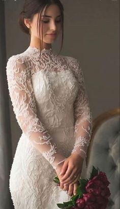 a woman in a wedding dress holding a bouquet