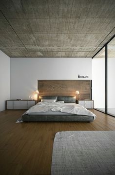 a bed room with a neatly made bed and wooden floors