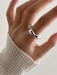 Editor's Notesmoire_ presents a wavy ring with plump silhouette. It is a unique ring that you can wear daily and layer on other rings. - Wavy open shape- Glossy surface- Made of silver 925- Plump silhouette- Sophisticated and unique moodMeasurements(in.)- One Size Composition & Care- Material: Silver 925- Plated products may discolor over time due to their nature.- Please be careful that discoloration may proceed faster in chemical substances, water, and heat.- As all jewelry produ Elegant Irregular Rings For Gifts, Modern Adjustable Rings With Irregular Shape, Modern Adjustable Irregular Rings, Modern Irregular Jewelry, Adjustable Bypass Ring With Modern Twist, Modern Twist Adjustable Bypass Ring, Midi Rings With Open Band And Modern Twist, Modern Twist Midi Rings With Open Band, Wavy Ring