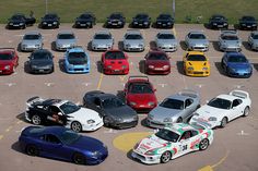 a parking lot filled with lots of different colored cars