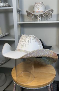 If a discount is present, it applies only to clear and clear ab stones. All other colors will have a surcharge after purchase.   I want to point out that each hat is hand-crafted. They are not without blemishes and there are no refunds as each hat is custom-made. 1) What date do you need your hat by? 2) If you know your hat size (E.g. 7 1/8) tell us. If not, watch these two YouTube videos. Measure with a SOFT tape.... Youtu.be/AwF7euDtI68 .... Youtu.be/WlDH956DMuI -Add rhinestone text for $7 per letter. Add vinyl text or logo. Price is dependent on design. Primary color= Stone color. Secondary= Hat color. Shop link for more products- www.etsy.com/shop/RhinestoneRodeo7 Rhinestone Fringe Cowboy Hat, White Party Hat With Rhinestones, Fringe Cowgirl Hat, Rhinestone Cowboy Hat, Space Costume, Bridesmaids Outfits, Space Costumes, Wedding Country, Space Cowboys