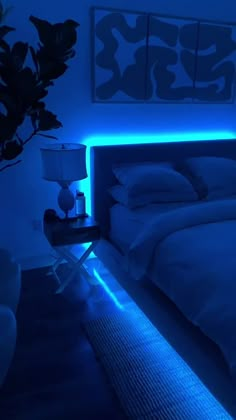 a bedroom with blue lighting and a bed