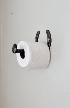 a roll of toilet paper is hanging on the wall