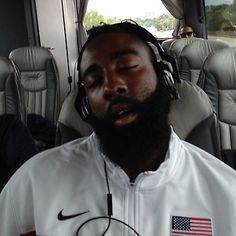 a man with headphones on sitting in an airplane