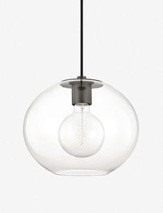 a clear glass light fixture hanging from a black ceiling lamp with an oval design on the bottom