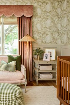 a baby's room with green and pink decor, including a crib bed