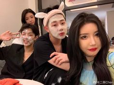 four people with bunny ears on their heads posing for a photo in front of a mirror