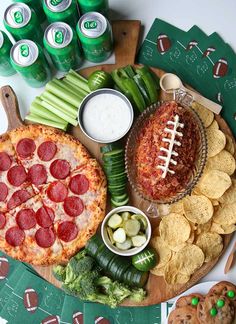 a platter with pizza, celery, pickles and chips