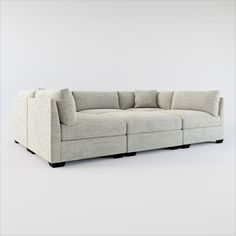 a white couch sitting on top of a gray floor next to a wall with no one in it