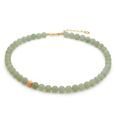 The Jade Forest Green Necklace features pale green minerals interspersed with a 24ct gold plated brass, rustic-textured bead, creating a unique overall effect. Beyond the pleasant harmony of the colors, jade is known for its calming effect and its ability to create inner peace and harmony. The necklace makes a beautiful set with the matching Jade Forest Green Earrings and Bracelet. Handmade in our Budapest studio. MATERIAL: 24 carat gold plated brass  STORAGE/CLEANING: Store your Eva Remenyi jewellery separate from other jewellery to prevent scratches and protect gold-plating Clean with a soft cloth or a special jewellery cleaning cloth Elegant Gold Amazonite Necklace, Gold Aventurine Beaded Necklaces, Gold Single Strand Amazonite Beaded Necklace, Gold Single Strand Beaded Necklace With Amazonite, Spiritual Gold Jade Beaded Necklaces, Gold Jade Gemstone Beaded Necklaces, Gold Aventurine Beaded Jewelry, Gold Beaded Jade Necklace, Gold Jade Beaded Necklaces With Gemstones