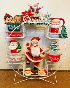 a santa clause figurine sitting on top of a metal rack with christmas decorations