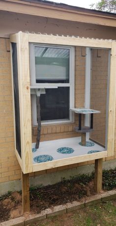 a wooden bench sitting in front of a window