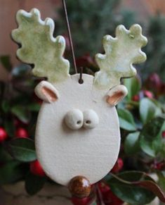 a ceramic deer ornament hanging from a tree