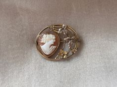 "This lovely brooch features a heart shaped genuine carved shell cameo portrait of a lady set in a gold plated frame with lovely detailed leaves, flowers, and an open art nouveau style design. It measures 1 3/8\" x 1 1/16\" and is in great condition with a little patina from age." Victorian Revival, Floral Rosa, Open Art, Carved Shell, Plate Frames, Gold Floral, Marie Antoinette, Bride Bridal, Women Set