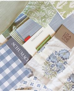 many different fabrics are stacked on top of each other, including one blue and white checkerboard