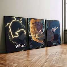 three anime posters on the wall in an empty room with hard wood flooring and white walls