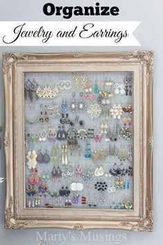 a white frame holding many pairs of earrings