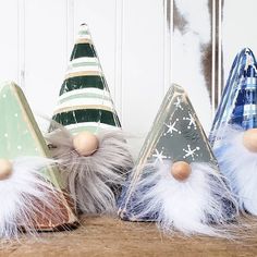 three small gnome hats sitting on top of a wooden table