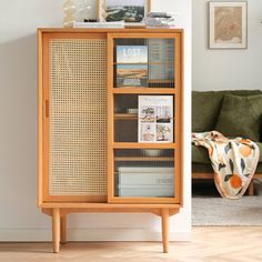 a wooden cabinet with books on it in a living room