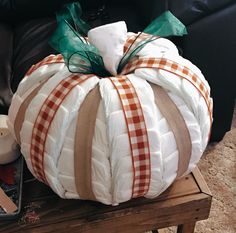 a large white pumpkin sitting on top of a wooden table