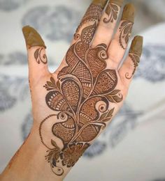 a person's hand with hennap on it and an intricate design in the middle