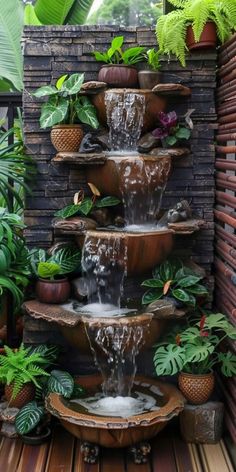 an outdoor fountain with plants surrounding it