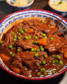 a bowl filled with meat and peas on top of a table