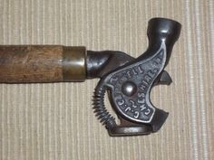 an old metal object with a wooden handle