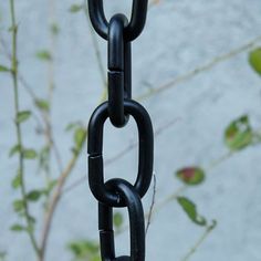 a black chain hanging from the side of a tree