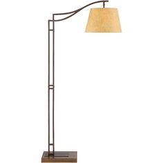 a lamp that is on top of a wooden base and has a light shade over it