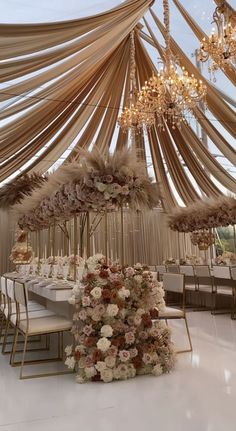 an elegant wedding setup with flowers and chandeliers