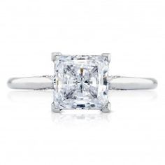 an engagement ring with a princess cut diamond in the center