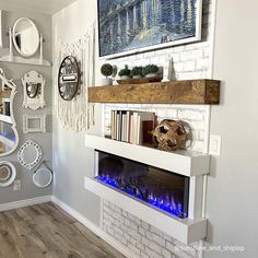 a living room with a fire place in the center and various decorations on the wall