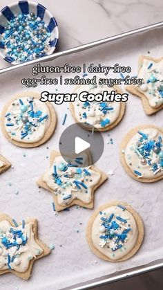 cookies with blue and white sprinkles are on a cookie sheet