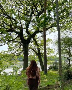 a woman walking down a path in the woods