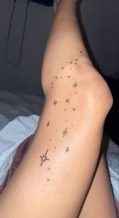 a woman's arm with stars on it