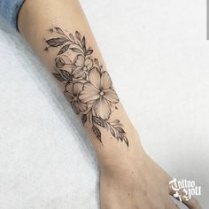 a woman's foot with a flower tattoo on it