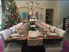 a dining room table set for christmas dinner