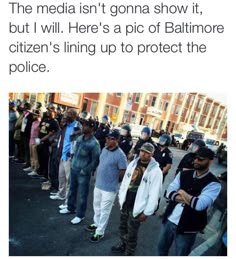 there are many people standing in the street with one person holding an american flag and another is