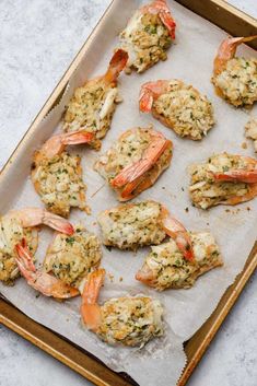 cooked shrimp and crab cakes on a baking sheet