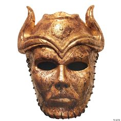 a gold mask with horns on it's head is shown against a white background