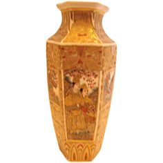 a decorative vase with an image of people on it