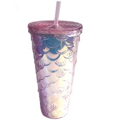 a glass cup with a straw in it on top of a white surface and pink rim