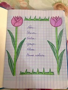 an open notebook with flowers drawn on it and some writing in the bottom right corner