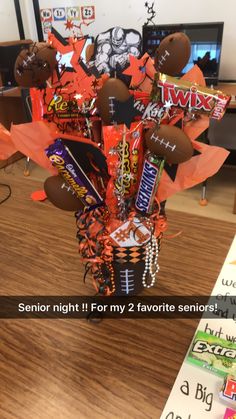 an arrangement of candy and candies in a basket on a table with the words, senior night it for my 2 favorite seniors