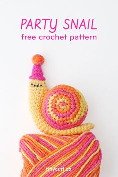 a crocheted snail sitting on top of a ball of yarn with the text party snail free crochet pattern