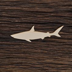 a wooden cutout of a shark on a piece of wood