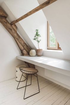 a chair and potted plant on a white shelf