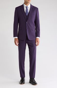 Bring understated elegance to the table in this three-piece suit crafted from rich fabric in a classic single-breasted silhouette. Jacket has notched lapels; chest welt pocket; front flap pockets Vest has front button closure; V-neck Pants have zip fly with button closure; front slant pockets; back button-welt pockets Jacket and vest are lined; trousers are lined to the knee 65% polyester, 35% viscose Dry clean Imported Suit has a 6” drop, meaning that a size 38R jacket is paired with size 32 pa Fitted Purple Suit For Formal Occasions, Fitted Purple Formal Suit, Fitted Purple Suit With Collar, Classic Purple Notch Lapel Suit, Classic Fitted Purple Blazer, Fitted Purple Suit, Tailored Purple Suit With Notch Lapel, Purple Tailored Suit With Notch Lapel, Tailored Purple Three-piece Suit For Formal Occasions