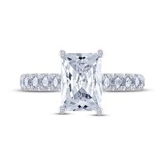 an engagement ring with a princess cut diamond and pave set diamonds on the band